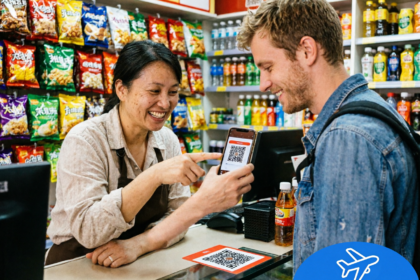 Foreign visitor using WeChat Pay to pay for snacks at a store